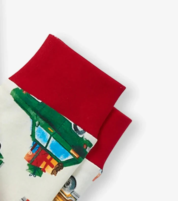 Closeup of Hatley boys organic cotton pajama cuff with red trim and festive vehicle artwork.