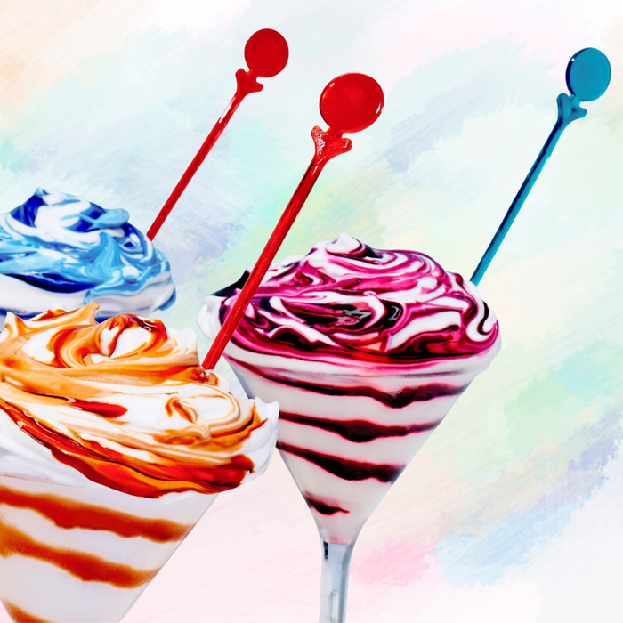 Colorful ice cream milk_shake with spoons on a multicolored background
