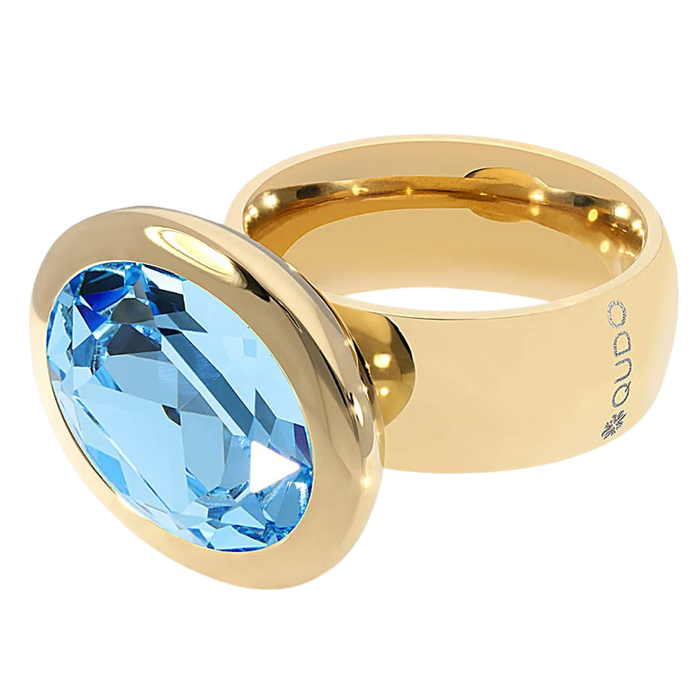 Gold ring with a blue gemstone on a white background