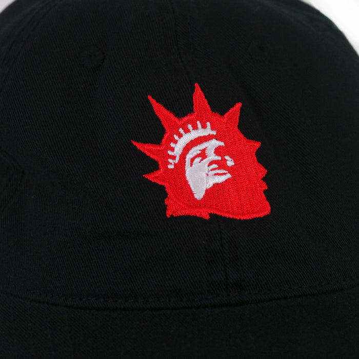A close-up of a black fabric surface with an embroidered red and white Liberty Red Logo, resembling the Statue of Liberty, by Trophy Eyesโperfect for any Black Dad Hat.