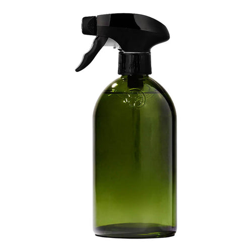 Green apothecary glass bottle with a spray trigger.