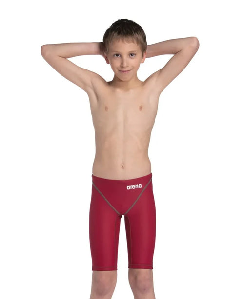 Arena Boys Powerskin ST Next Jammer in deep red, close-up of the competitive swim jammers with sleek fabric and branding details.