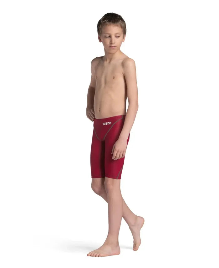 Arena Boys Powerskin ST Next Jammer in deep red, featuring a sleek swim jammer design for young swimmers.