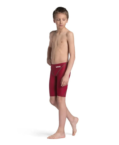 Arena Boys Powerskin ST Next Jammer in deep red, featuring a sleek swim jammer design for young swimmers.