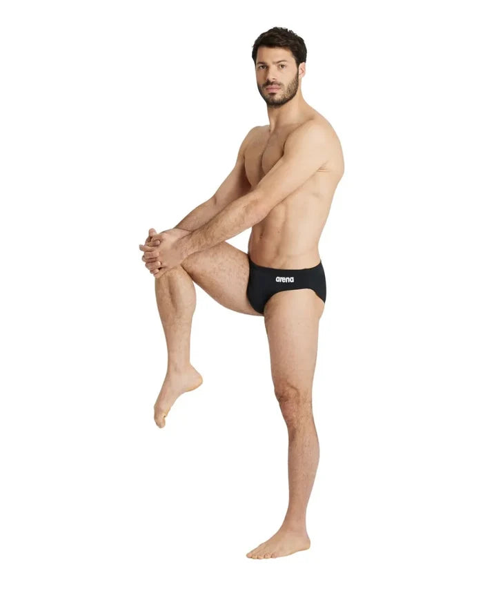 Black Arena men's team swim briefs, snug fit, with the brand logo visible, designed for competitive swimming.