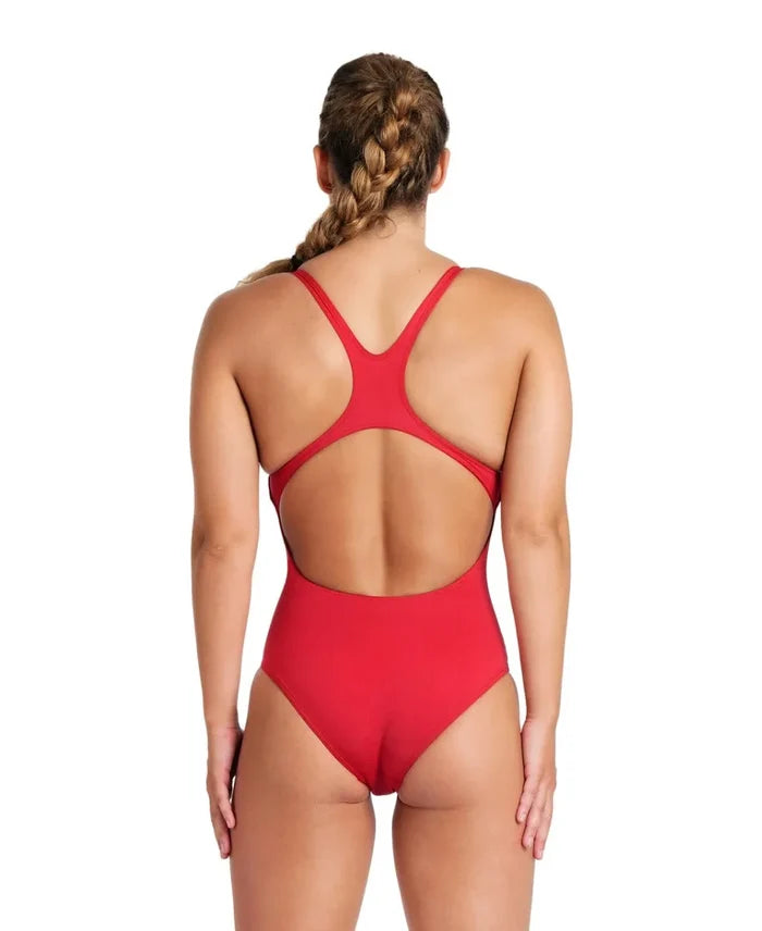 Red Arena Women's Team Swim Pro solid swimsuit, sleek and fitted for competitive swimming, shown on a model.