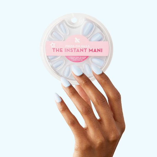 BP - Press-On | Medium | Almond showing hand with medium almond light blue press-on nails next to packaging