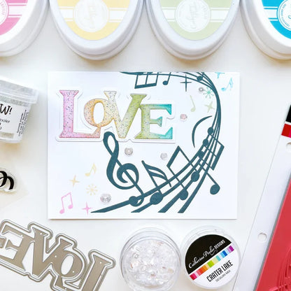 Catherine Pooler - Background Stamp - On Staff. Add some dancing notes to your card background with the On Staff Background Stamp. This red rubber stamp features a winding music staff pattern with notes and musical icons. Available at Embellish Away located in Bowmanville Ontario Canada. Card example by brand ambassador.