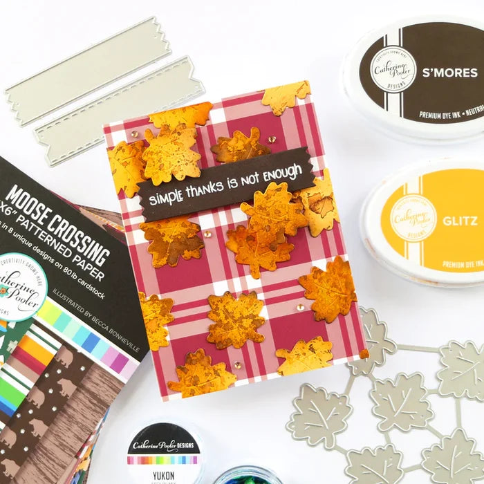 Catherine Pooler - Patterned Paper - Moose Crossing. Oh the beauty of the land and heritage of Canada! The Moose Crossing Patterned Paper celebrates this with patterns including moose, mountains, inuksuks, bears, woodgrain and maple leaves. Available at Embellish Away located in Bowmanville Ontario Canada. card by brand ambassador.