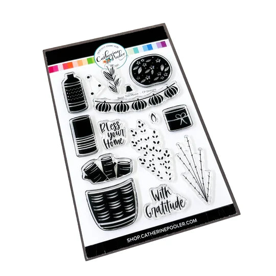 Catherine Pooler - Stamp & Die Set - Bless This House. Create a card inspired by the latest fall themed home decor trends with this Set. This set features warm and cozy fireside decor images like candles, a vase and basket of wood. Available at Embellish Away located in Bowmanville Ontario Canada.