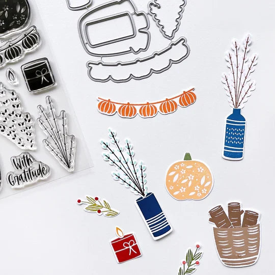 Catherine Pooler - Stamp & Die Set - Bless This House. Create a card inspired by the latest fall themed home decor trends with this Set. This set features warm and cozy fireside decor images like candles, a vase and basket of wood. Available at Embellish Away located in Bowmanville Ontario Canada. Example by brand ambassador.