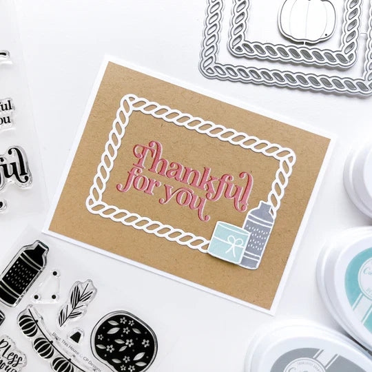 Catherine Pooler - Stamp & Die Set - Bless This House. Create a card inspired by the latest fall themed home decor trends with this Set. This set features warm and cozy fireside decor images like candles, a vase and basket of wood. Available at Embellish Away located in Bowmanville Ontario Canada. Example by brand ambassador.