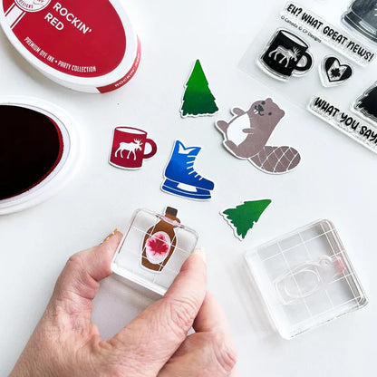 Catherine Pooler - Stamp & Die Set - O Canada. This one is sweeter than maple syrup, eh? Here's too the beautiful country of Canada! This fun icons stamp & die set and it's has images of maple syrup, hockey, a Mountie hat and a hot cup of "Timmies" Available at Embellish Away located in Bowmanville Ontario Canada.
