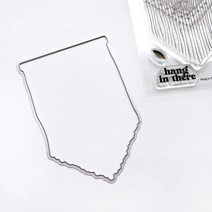 Catherine Pooler - Stamp & Dies Set - Hang in There. When you need to send a little encouragement, do it with the Hang in There Stamp Set. This 3x4 stamp set features a macrame wall hanging stamp and a tiny "hang in there" sentiment. Available at Embellish Away located in Bowmanville Ontario Canada.