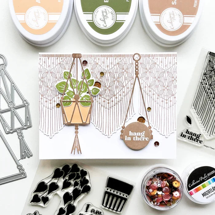 Catherine Pooler - Stamp & Dies Set - Hang in There. When you need to send a little encouragement, do it with the Hang in There Stamp Set. This 3x4 stamp set features a macrame wall hanging stamp and a tiny "hang in there" sentiment. Available at Embellish Away located in Bowmanville Ontario Canada. Card example by brand ambassador.