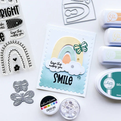 Catherine Pooler - Stamp & Dies Set - Smile Bright. Smile Bright! This 6x8 Stamp Set and coordinating dies are ready for you to piece it together to your hearts content to create a modern, boho rainbow. Available at Embellish Away located in Bowmanville Ontario Canada. Card example by brand ambassador.