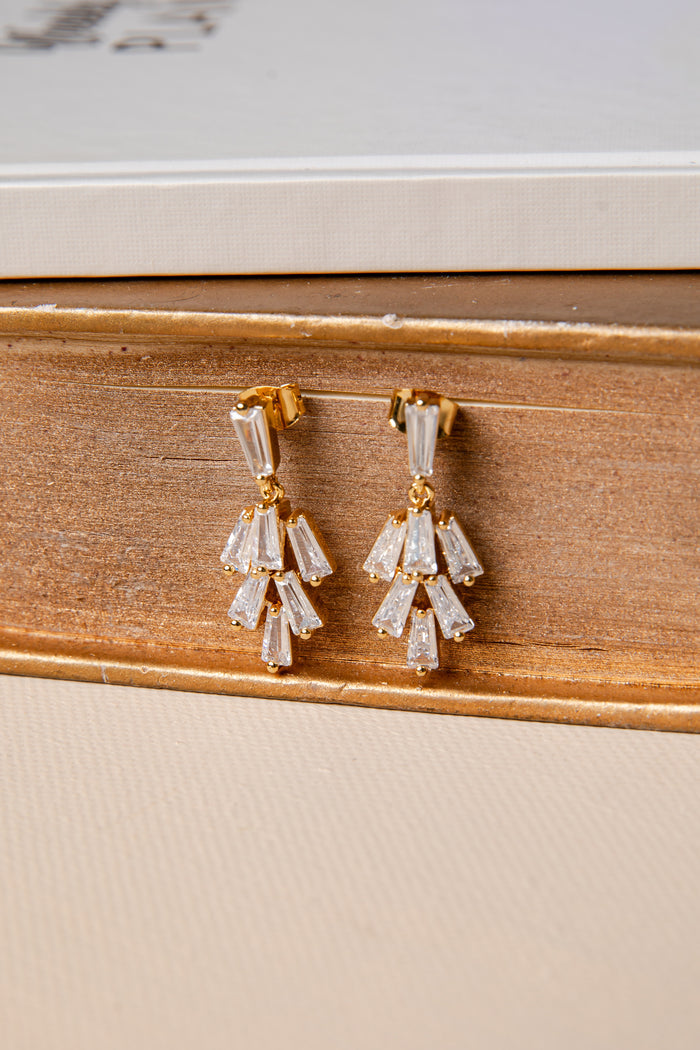 Pair of diamond earrings on a wooden surface