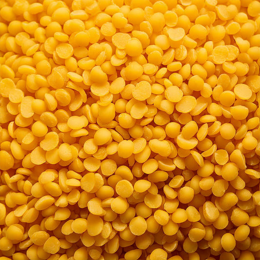Organic Yellow Beeswax Pellets displayed as small golden pellets for skincare and cosmetic formulations