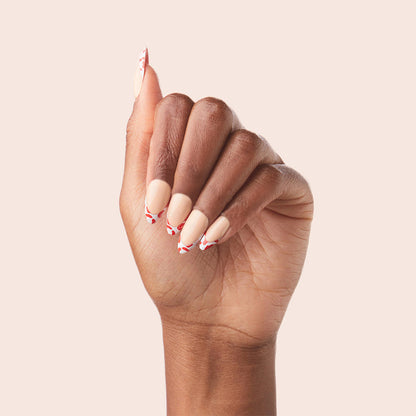 Cheetah French - Press-On | Long | Almond showing hand with long almond press-on nails in fiery red cheetah tip manicure