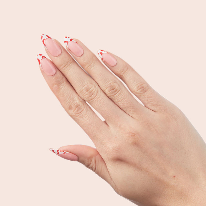 Cheetah French - Press-On | Long | Almond showing hand with long almond press-on nails featuring fiery red cheetah tipped french manicure