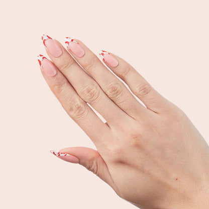 Cheetah French - Press-On | Long | Almond showing hand with long almond press-on nails featuring fiery red cheetah tipped french manicure