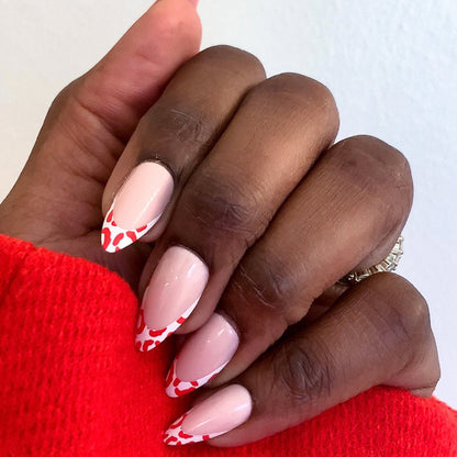 Cheetah French - Press-On | Long | Almond showing hand with long almond press-on nails with fiery red cheetah print tips manicure