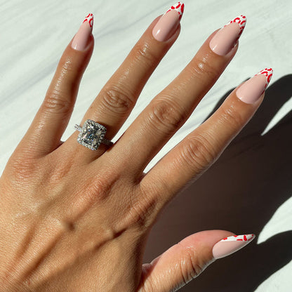 Cheetah French - Press-On | Long | Almond showing hand with long almond nails featuring bold red cheetah print french tips manicure