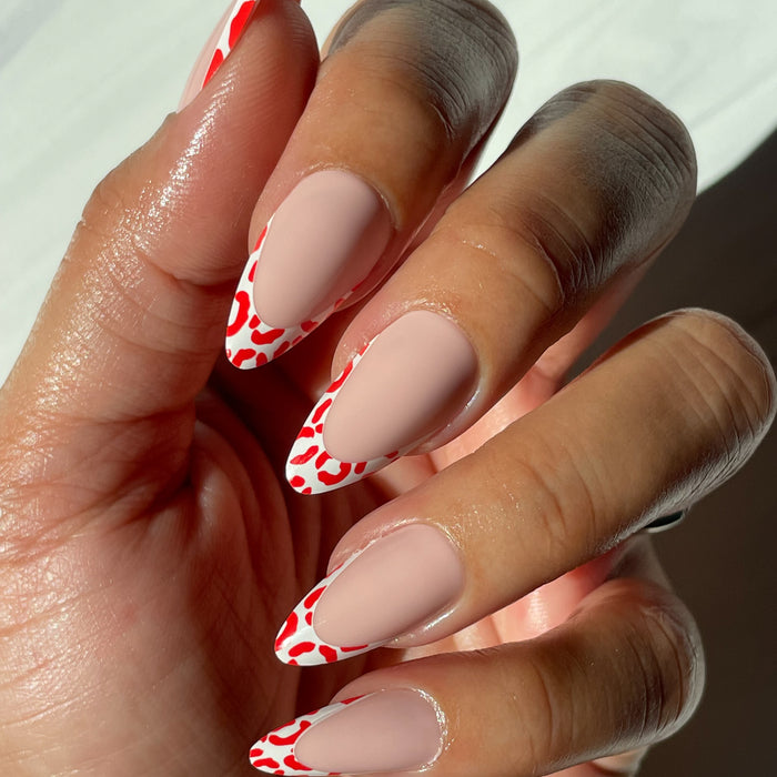 Cheetah French - Press-On | Long | Almond featuring long almond nails with fiery red cheetah print tips manicure