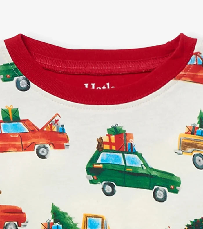 Closeup of Hatley boys Christmas Cars pajama top showing red neckline and holiday vehicle print.