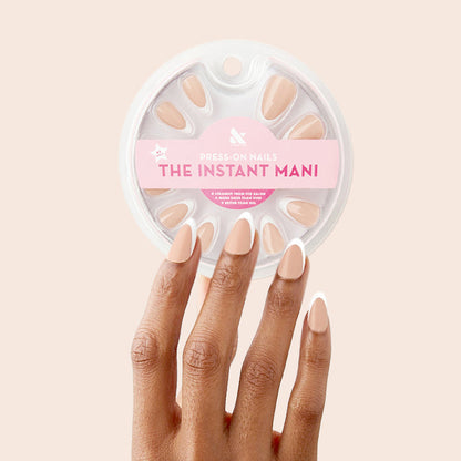 Classic French - Press-On | Medium | Almond showing hand with medium almond nails in neutral peach pink base and white tips manicure