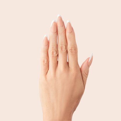 Classic French - Press-On | Medium | Almond showing hand with medium almond press-on nails featuring neutral peachy pink base and white tips