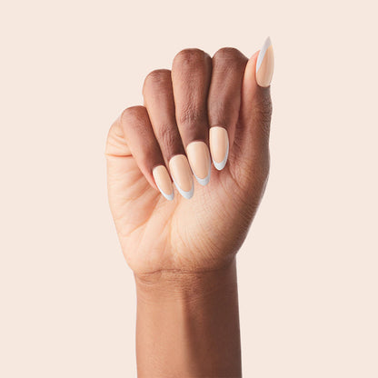 Classic French - Press-On | Medium | Almond showing medium almond false nails with peachy pink base and white tips manicure