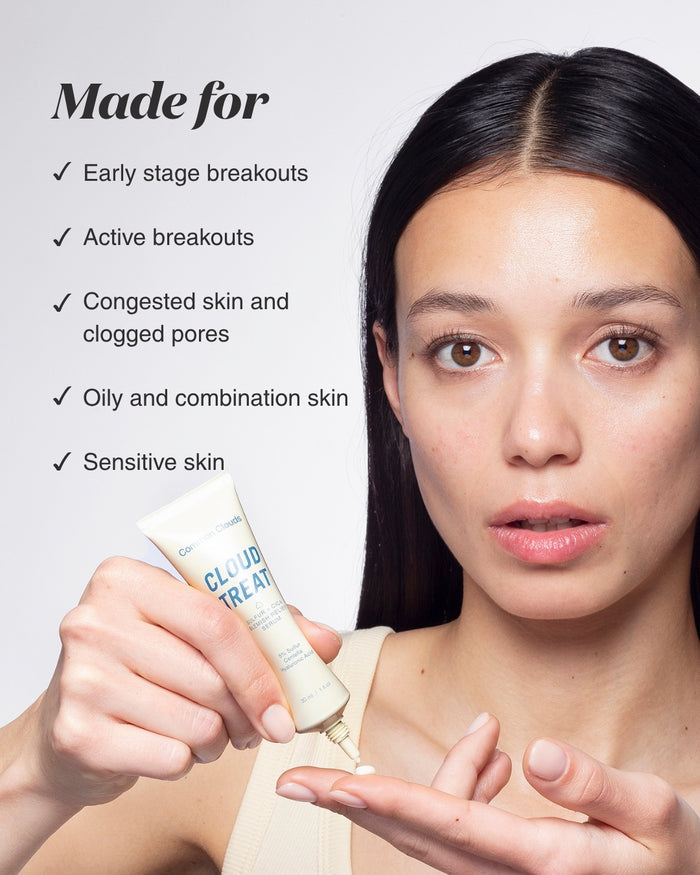 Woman holding a skincare product with text about skin conditions it addresses.