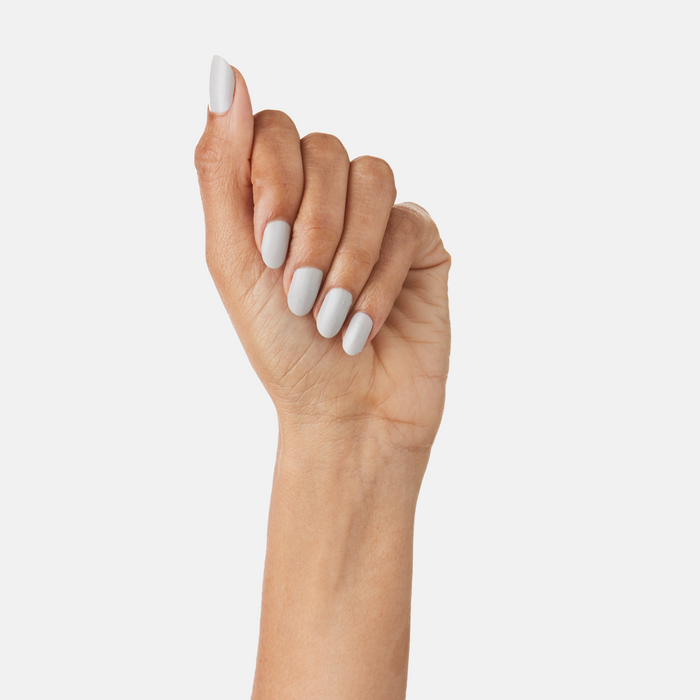 Hand with nails painted in soft misty grey using Cloudy Skies long-lasting polish for a sleek manicure look