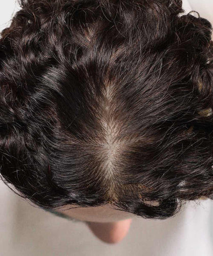 A top view reveals dark, wavy hair parted in the middle, with noticeable thinning and a visible scalp.