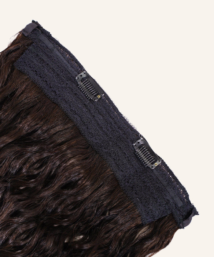 A close-up of Curly Perfect Crown Hair Extensions by Perfect Locks in golden brown , with black lace and two clips on a light background.#color_natural-black-(1B)