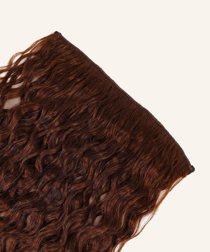 Curly Perfect Crown Hair Extensions by Perfect Locks in Toffee Blonde Highlights (4/27) are arranged against a simple, light backdrop.#color_chocolate-brown-(3)