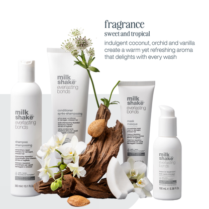 milk_shake everlasting bonds hair care products with flowers and driftwood on a white background