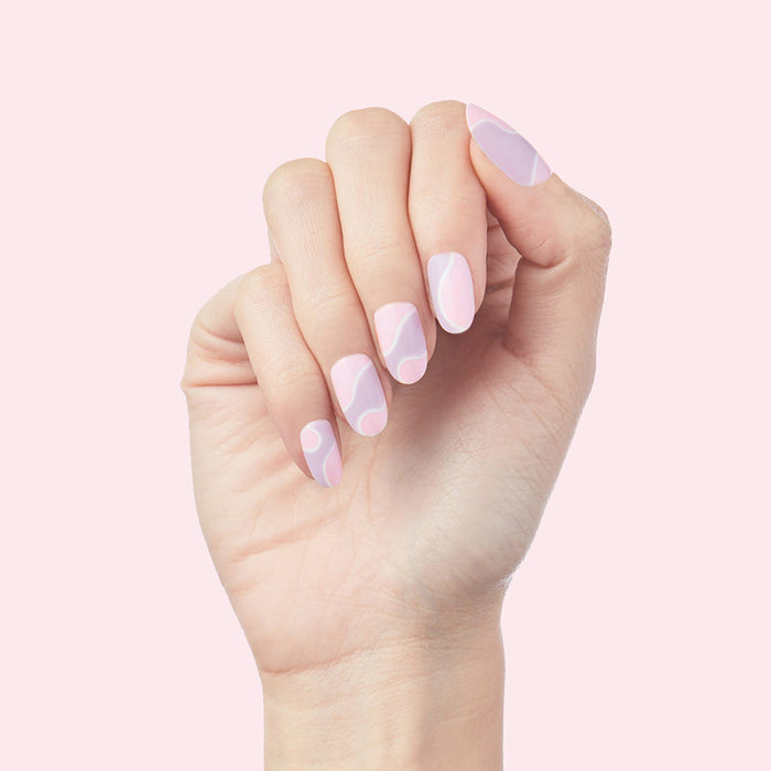 Groovy Swirl - Press-On | Medium | Oval showing medium oval false nails with pink and lavender swirl design on hand against pale pink background