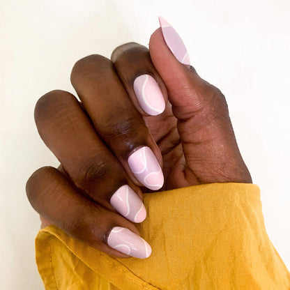 Groovy Swirl - Press-On | Medium | Oval showing medium oval press-on nails with pink and lavender swirl manicure on hand outdoors