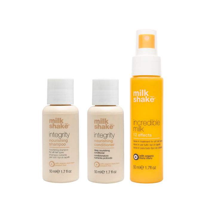 Three bottles of milk_shake integrity shampoo, conditioner and incredible milk mini on a white background