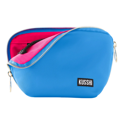 kusshi everyday makeup bag, light blue makeup bag, kusshi cosmetic bag, neon pink interior bag, travel makeup bag, stylish toiletry bag, kusshi blue pink bag, everyday beauty bag