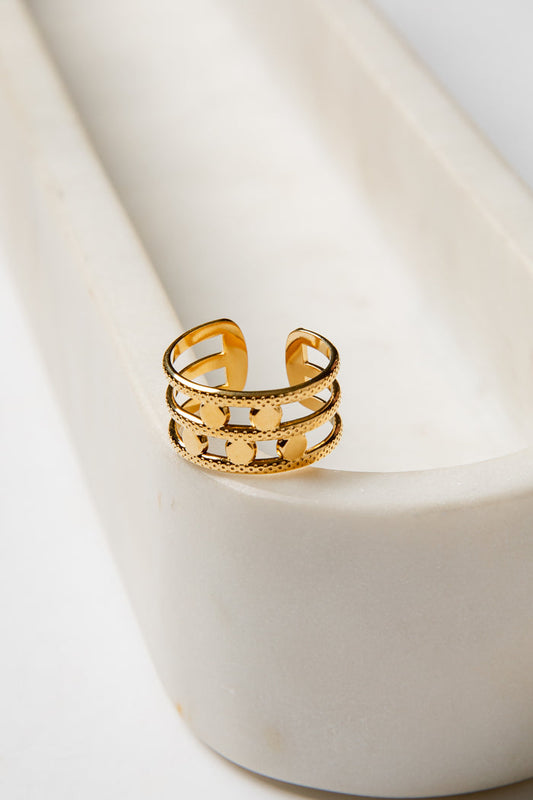 Gold ring on a white ceramic surface