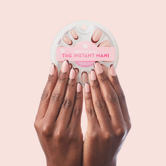 Modern French - Press-On | Medium | Oval showing medium oval false nails with neutral tonal french manicure design on dark skin tone hands