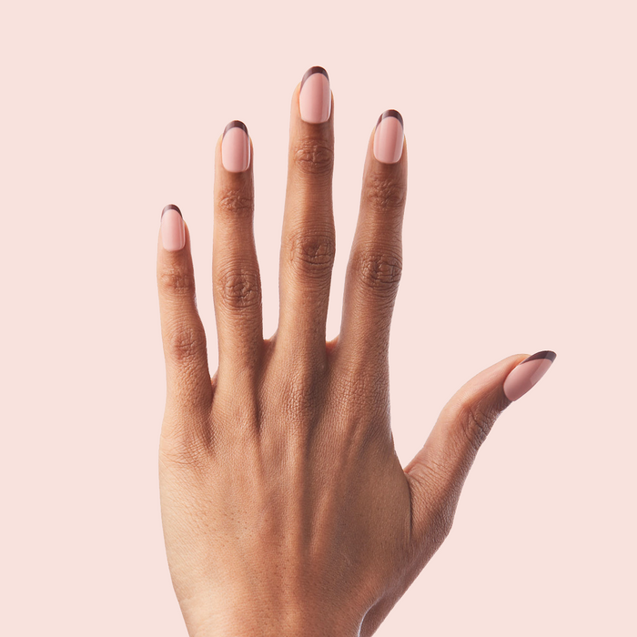 Modern French - Press-On | Medium | Oval hand with medium oval false nails in a chic tonal brown french manicure design