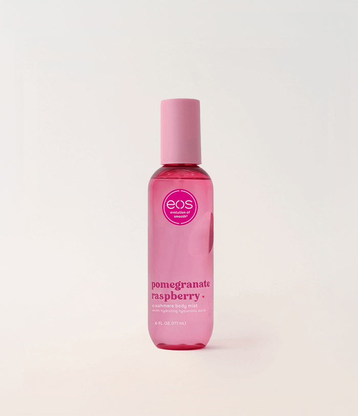 Pink bottle of EOS Pomegranate Raspberry body mist on a light pink background