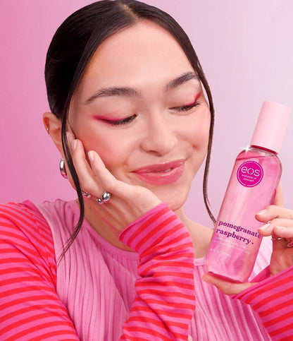 model holding pomegranate raspberry body mist