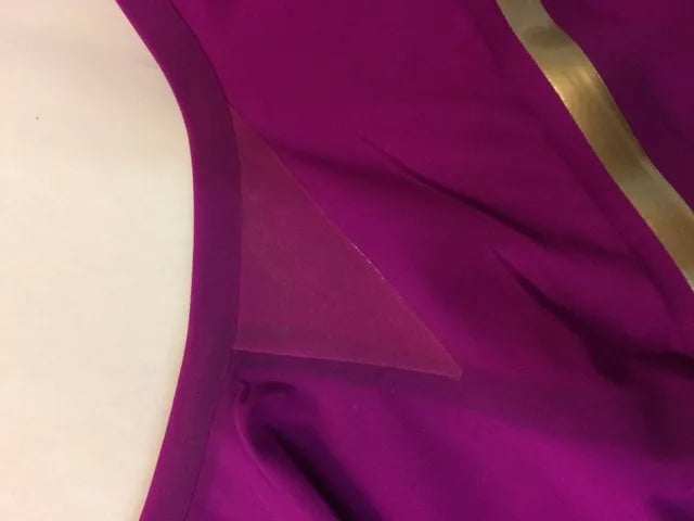 AK race suit repair service, showing a professional repair process on a high-performance racing suit for optimal fit and durability.