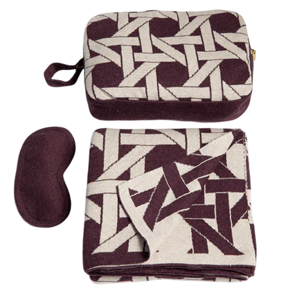 Set of travel items including a patterned eye mask and pouch on a white background