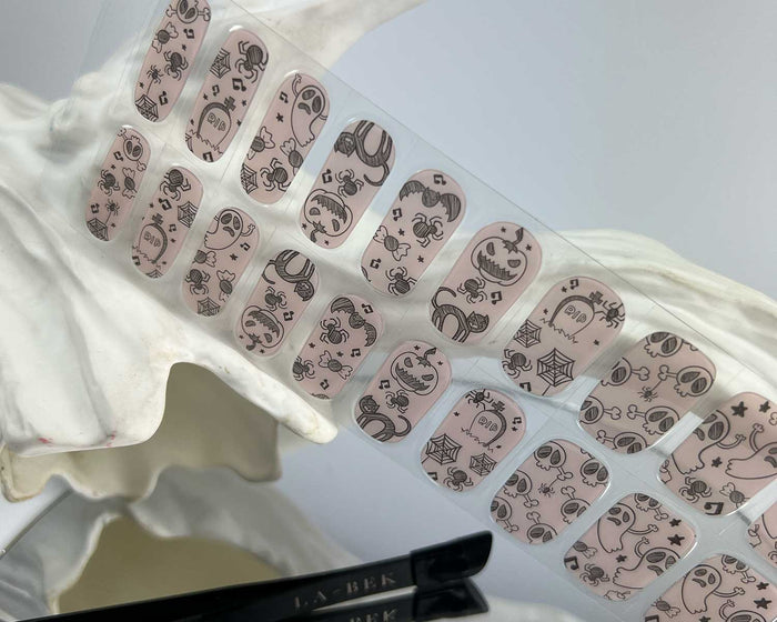 Spooky Sketches semi-cured gel nail wraps on a nail mock-up, close-up